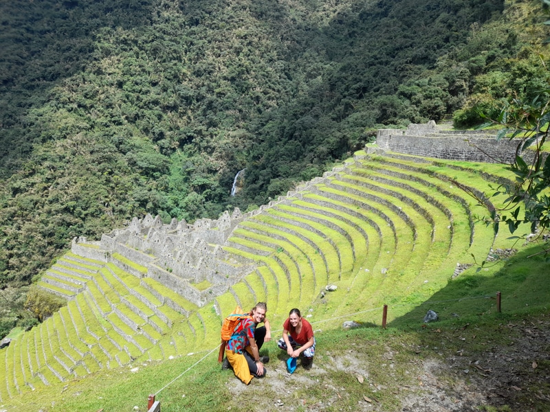 travelers visiting the archaeological site of wiñay wayna - Orange Nation